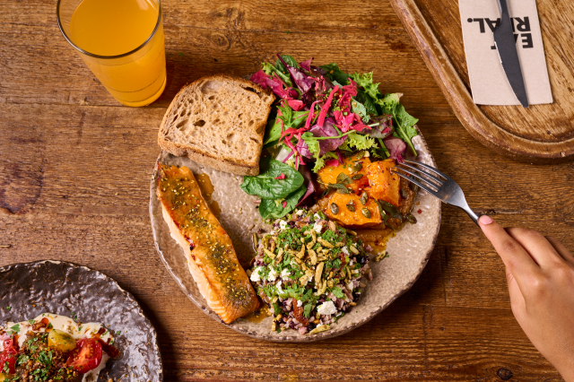 plate of healthy food with salmon, salad, and bread