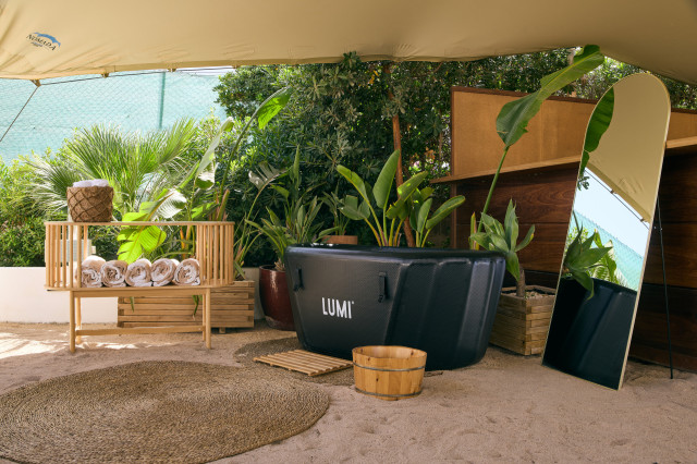 lumi therapy ice bath outside with mirror and potted plants 