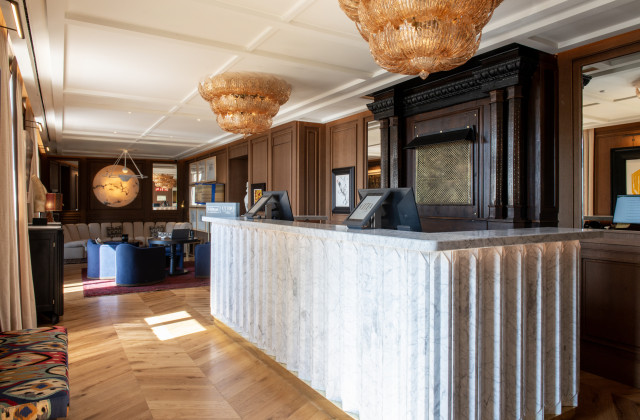 hotel lobby with parquet flooring and hanging chandeliers
