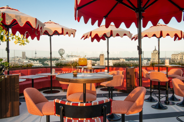 hotel rooftop in madrid with red umbrellas