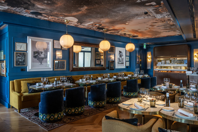 hotel restaurant with blue walls and round hanging lights
