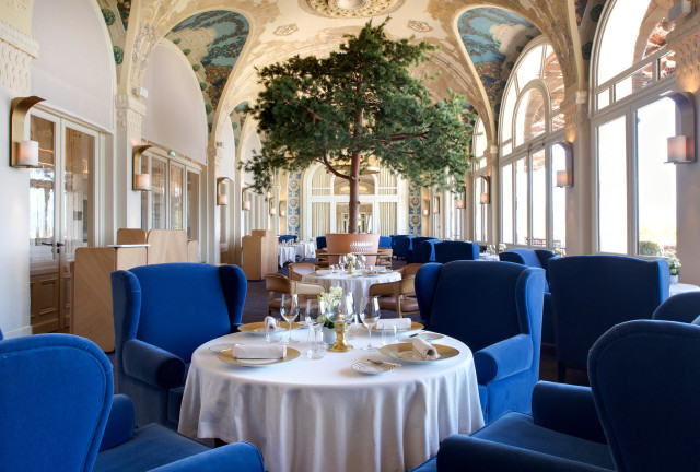 evian resort restaurant with blue velvet chairs 