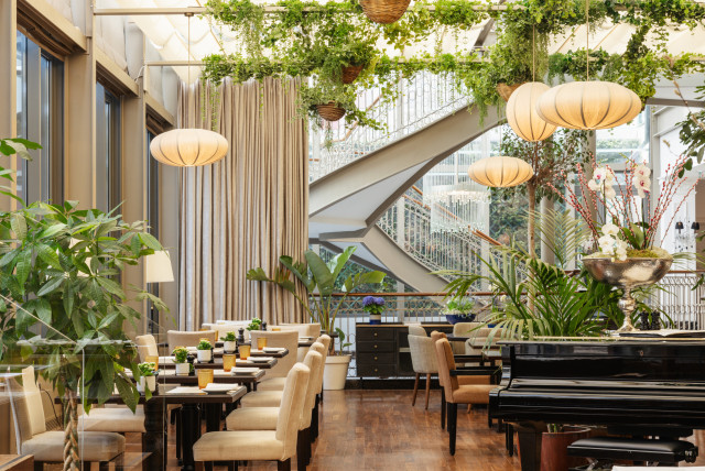 hotel dining room with hanging lights and piano