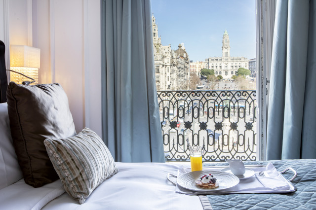 hotel bedroom with view of city