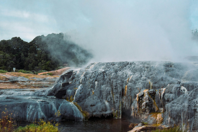 japanese onsen with steam rising into the air 