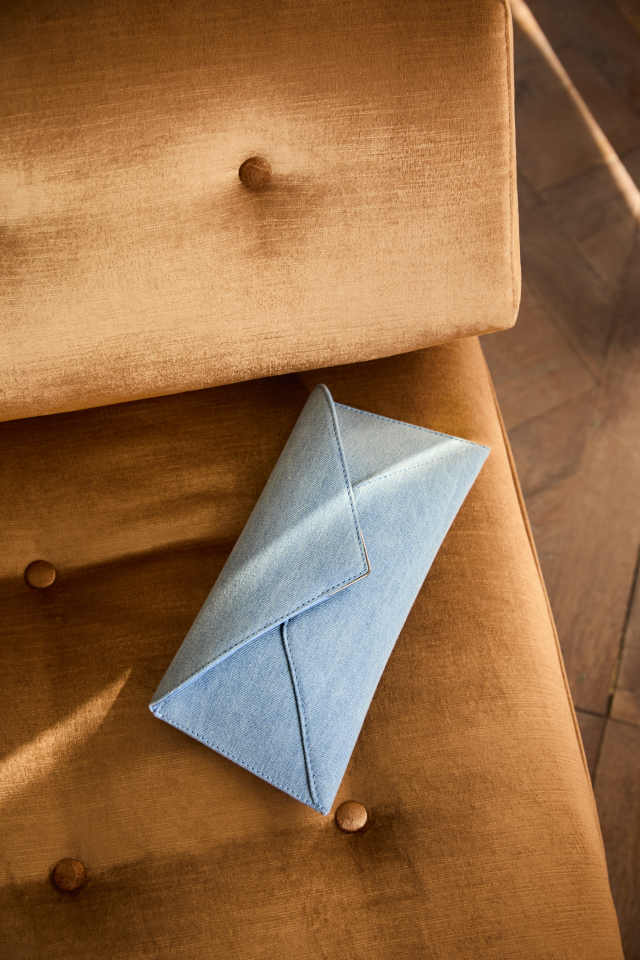 blue bag on burnt orange chair 