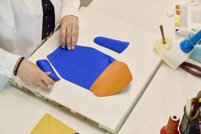 person making handbag in atelier 