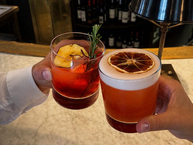 people clinking glasses of negronis at lanes of london