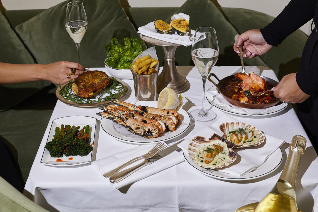 people tucking into seafood platters