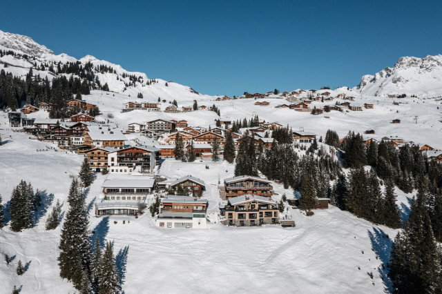 aerial view of le chalet perched among other chalets in austria