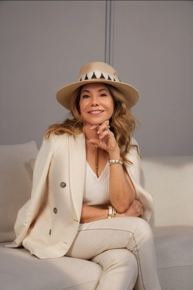 lucia penrod posing in cream outfit and straw hat 