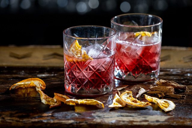 two negronis with dried orange slices at the lucky pig