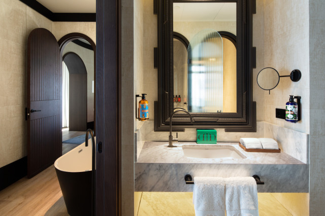 hotel bathroom with dark wood 