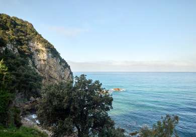 Hiking trail in corfu with a view of the blue sea.