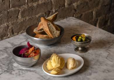 Array of small dishes on marble table in a restaurant .