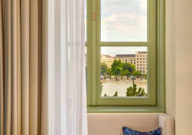 Hotel seating area with green window in the background.