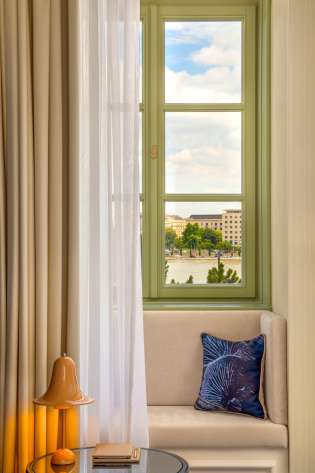 Hotel seating area with green window in the background.