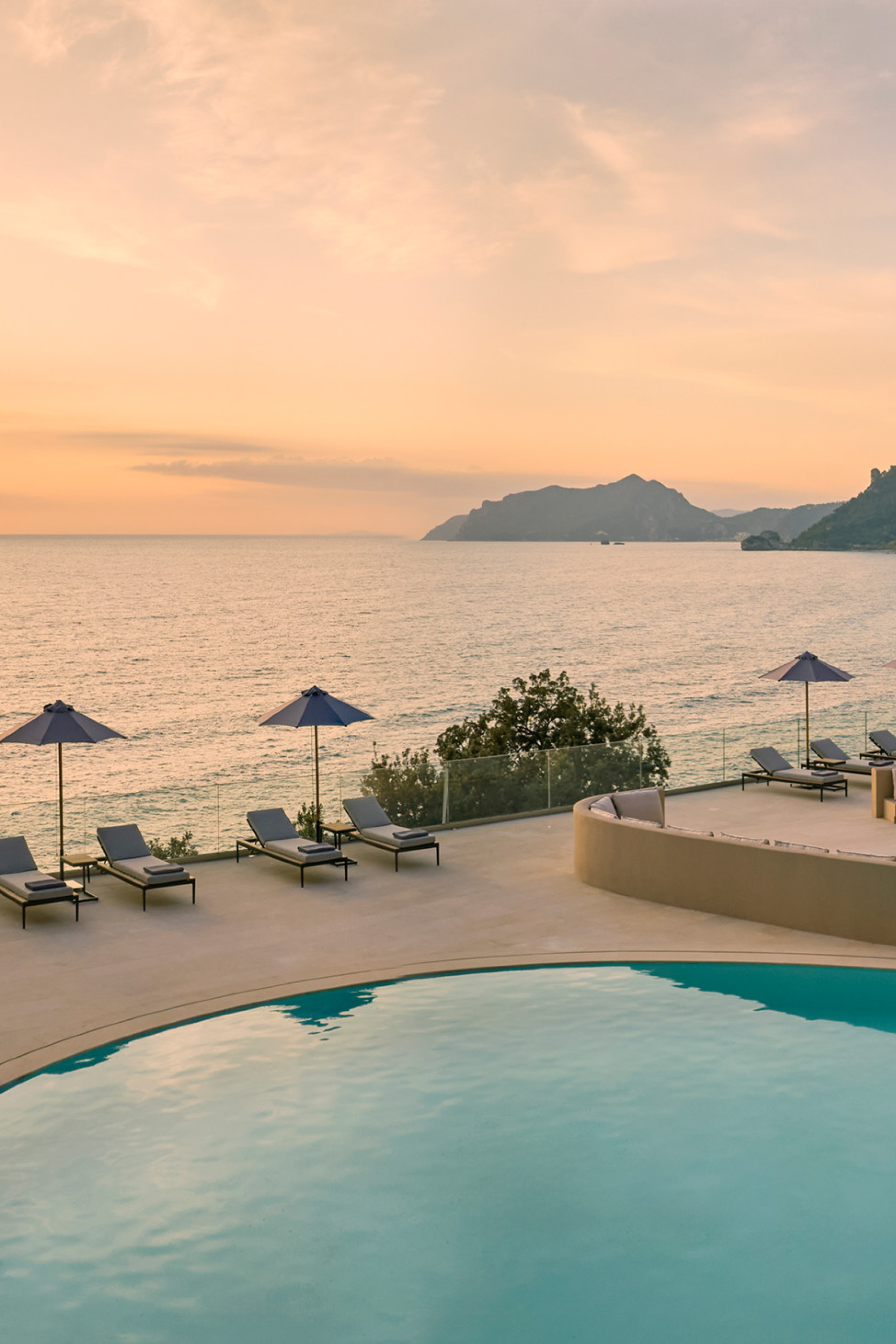 photo of hotel pool with the sunset in the background