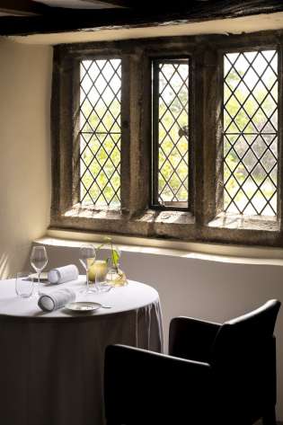 Interior of restaurant with stone windows.