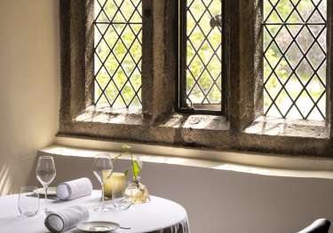 Interior of restaurant with stone windows.