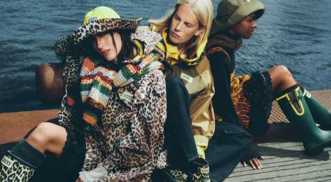 Ganni x hunter collaboration with ponchos and rain hats .