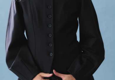 Model posing in tailored jacket with buttons.