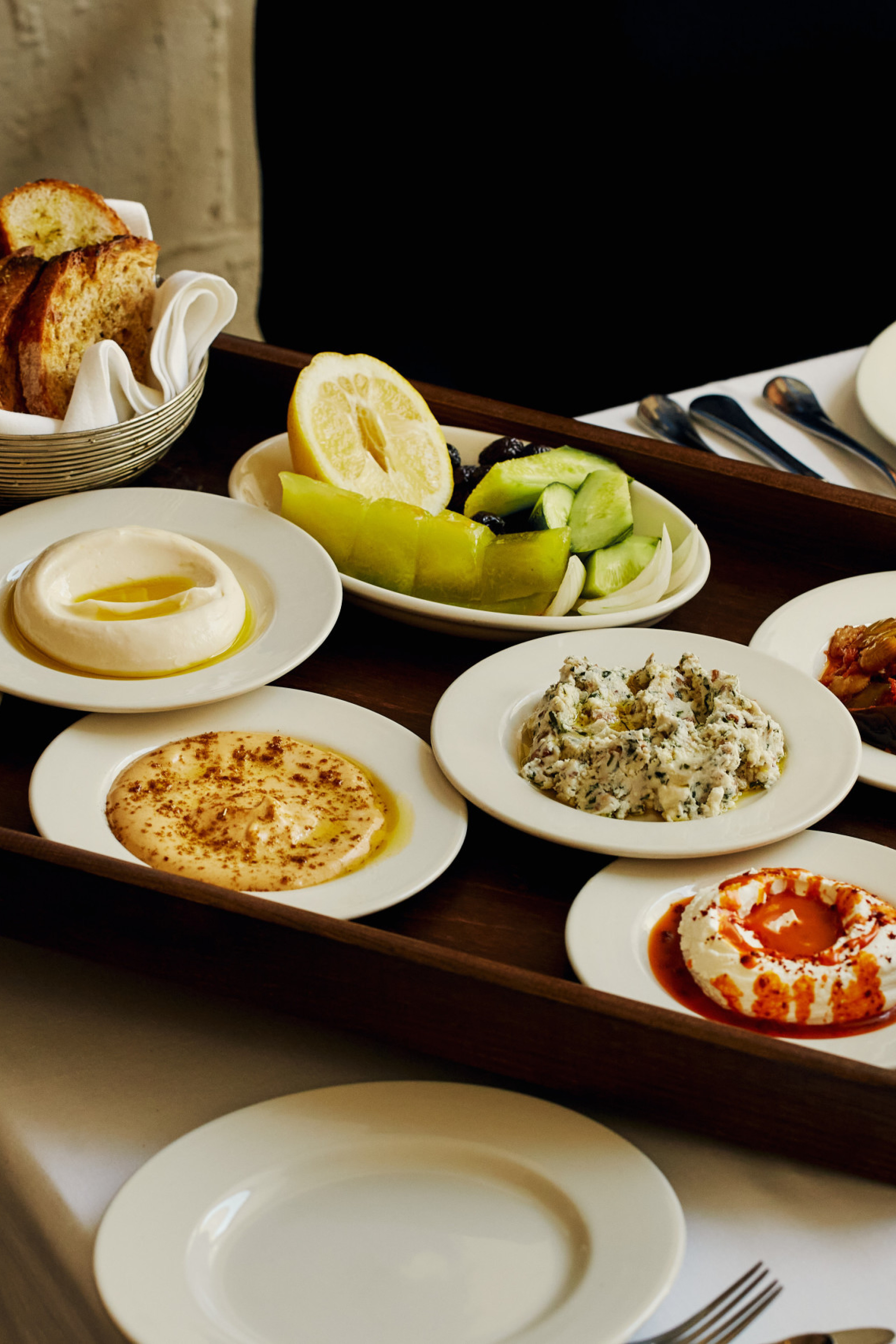 small plates on wooden tray being served at kismet restaurant