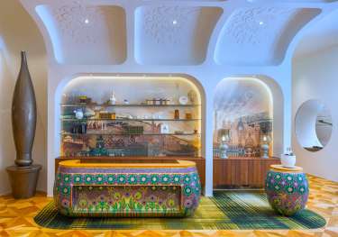 Kimpton bem budapest hotel reception with colourful check-in desk.