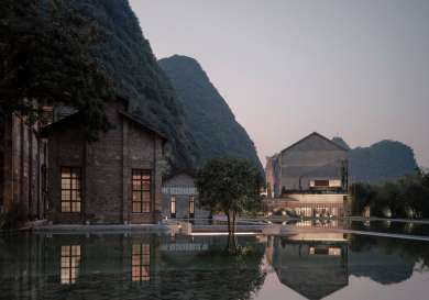 Hotel outbuildings around outdoor pool .