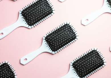 White paddle brushes on pink background.