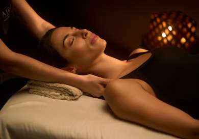 Woman getting neck massage .