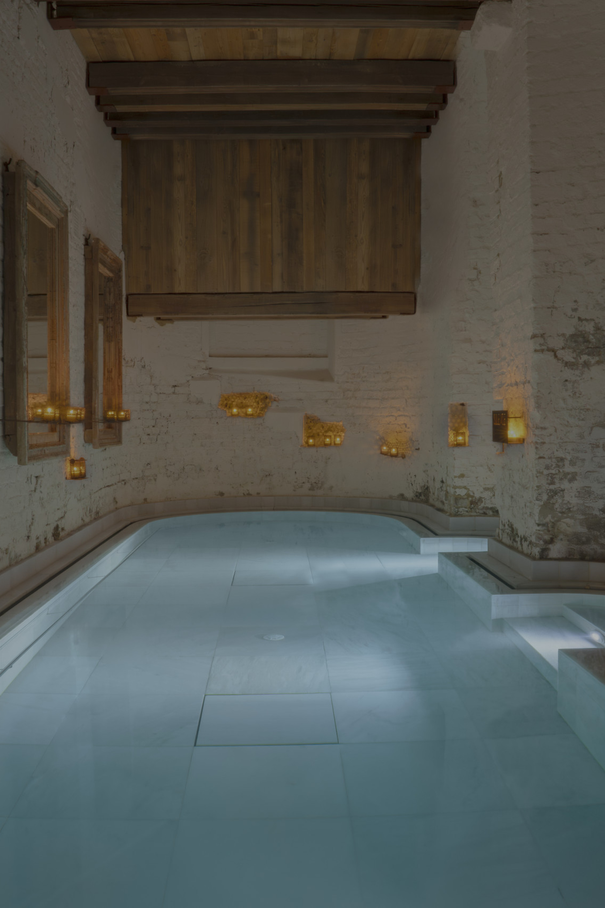 bath inside spa with candles dotted about