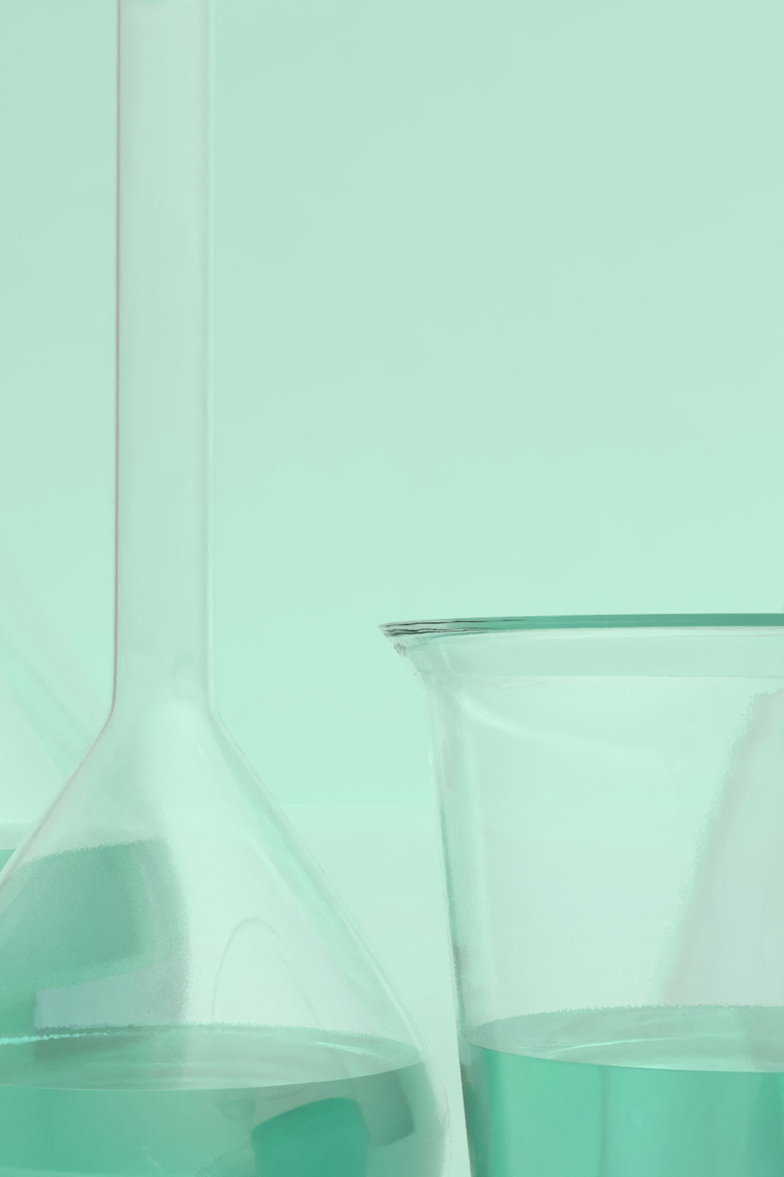 scientific beakers on mint-green background