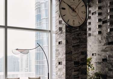 Hotel lobby area with giant clock on the wall .