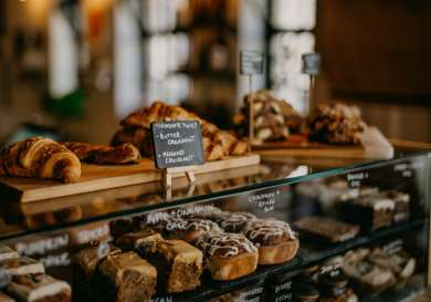 Pastries on glass display case in paris .