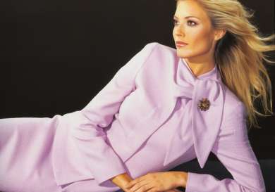 Model posing in pink skirt suit .