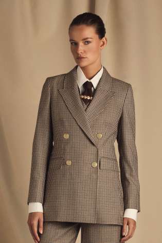 Model wearing holland cooper tartan blazer .