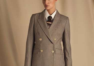 Model wearing holland cooper tartan blazer .