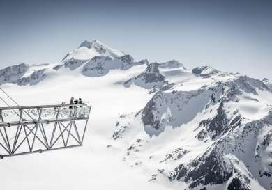People looking at snow-capped mountains.