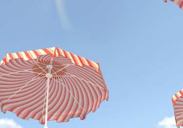 Red-and-white striped umbrellas jutting into blue sky.