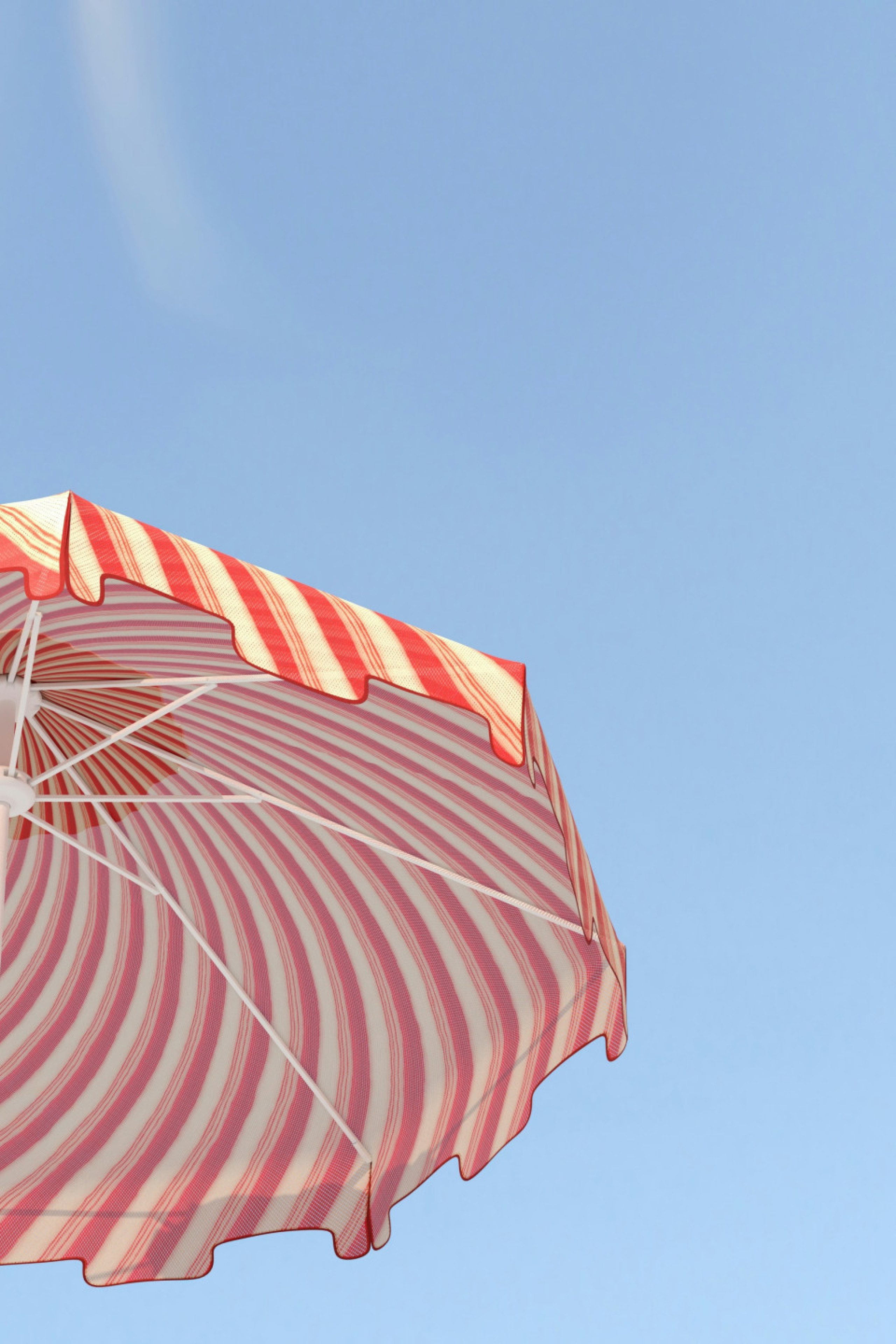 red-and-white striped umbrellas jutting into blue sky