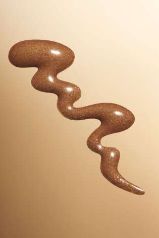 Bronzing drops on brown background.