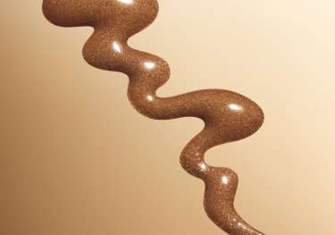 Bronzing drops on brown background.