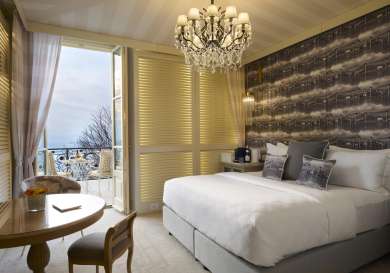 Hotel bedroom with balcony area .