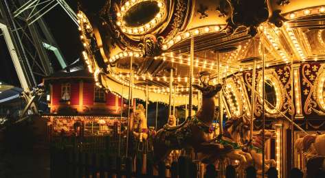 Illuminated carousel at christmas market .