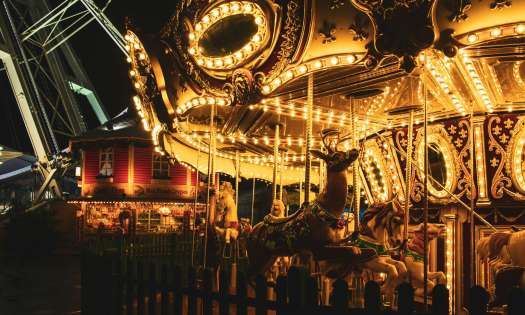 Illuminated carousel at christmas market .