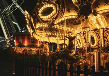 Illuminated carousel at christmas market .