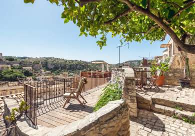 Hotel terrace with deck and chair.