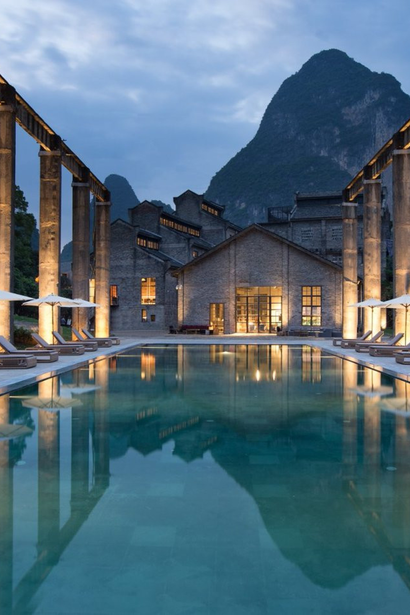 outside hotel pool with view of mountain in the background