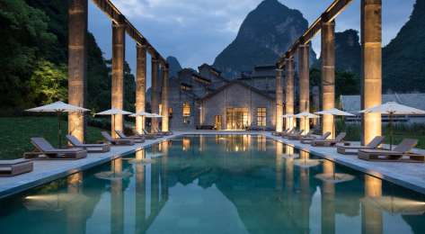 Outside hotel pool with view of mountain in the background.